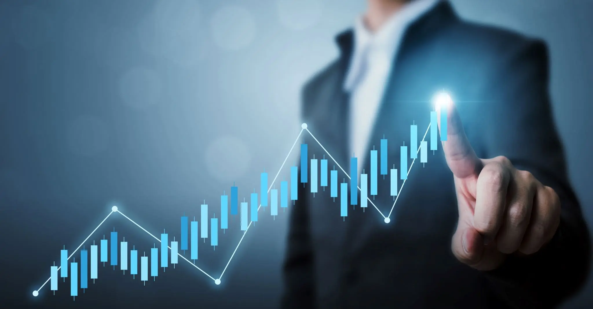 businessman pointing to a box and whisker market chart trending up
