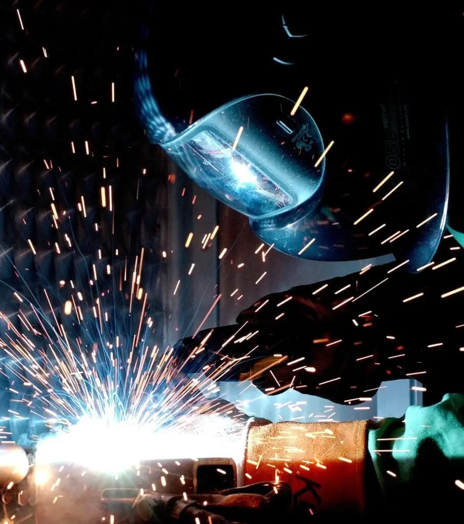 welder welding metal with thermal spray