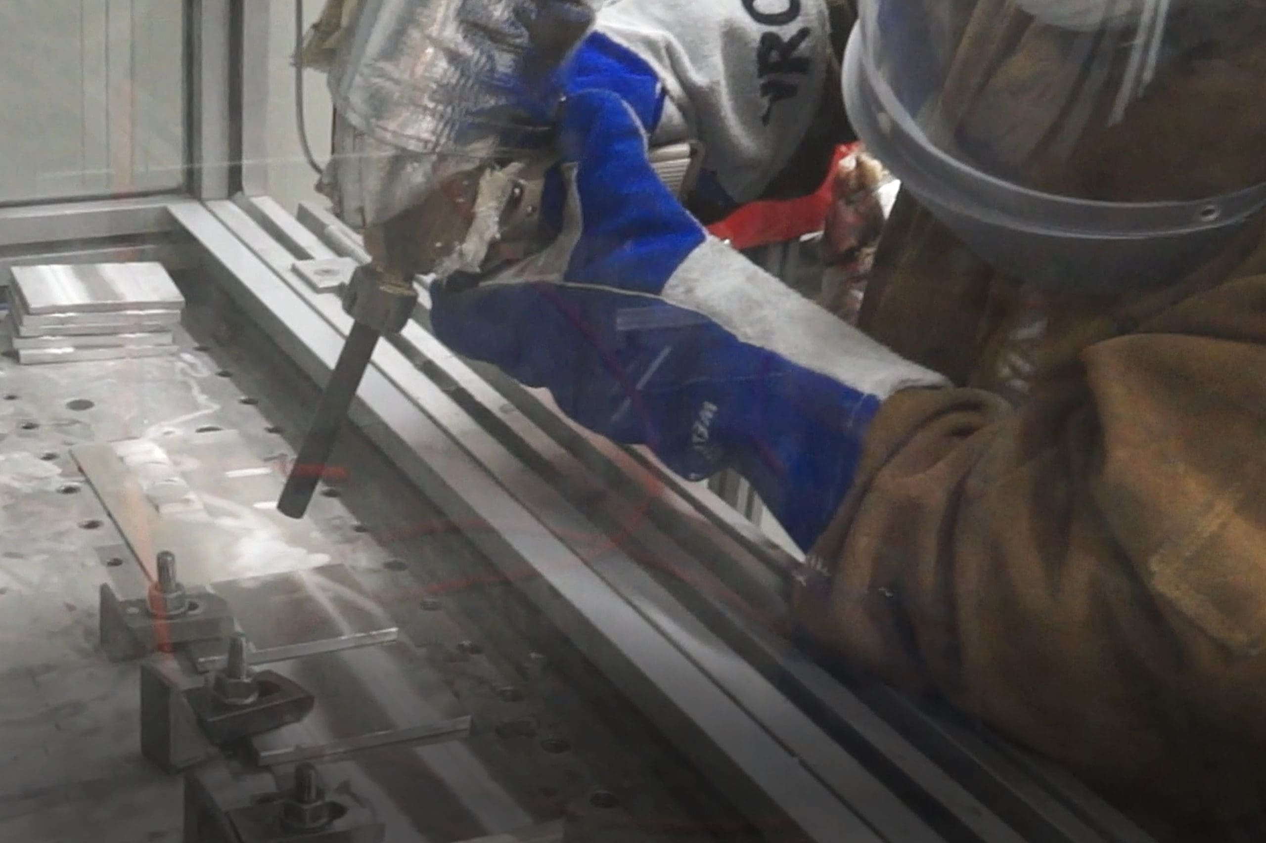 technician using Handheld Cold Spray nozzle spraying metal powders on to substrate