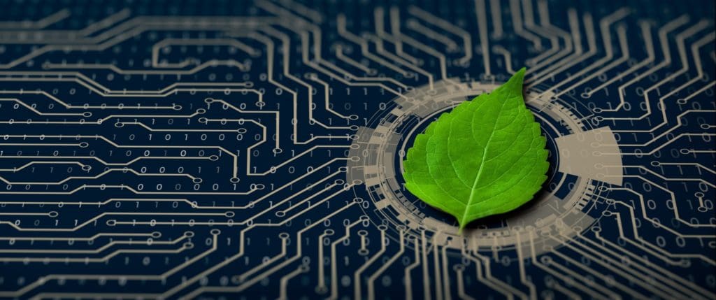 A green leaf on a computer circuit indicating that cold spray additive manufacturing is environmentally-friendly or "green:
