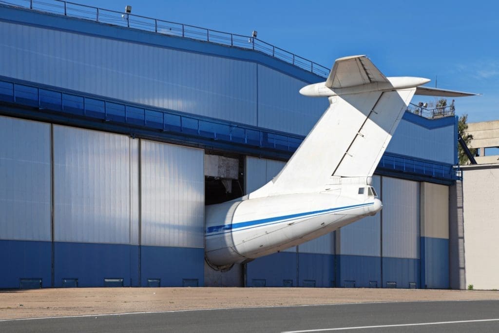 An airplane in a hangar getting ready for cold spray repair.